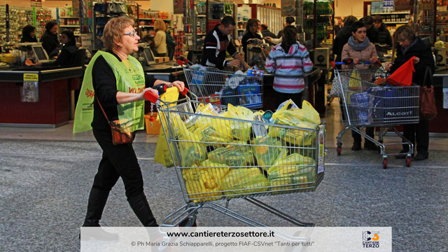 Una donna trasporta un carrello della spesa