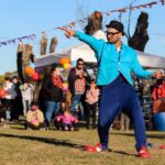 Energetic street performer captivates audience at an outdoor festival in Buenos Aires, Argentina.