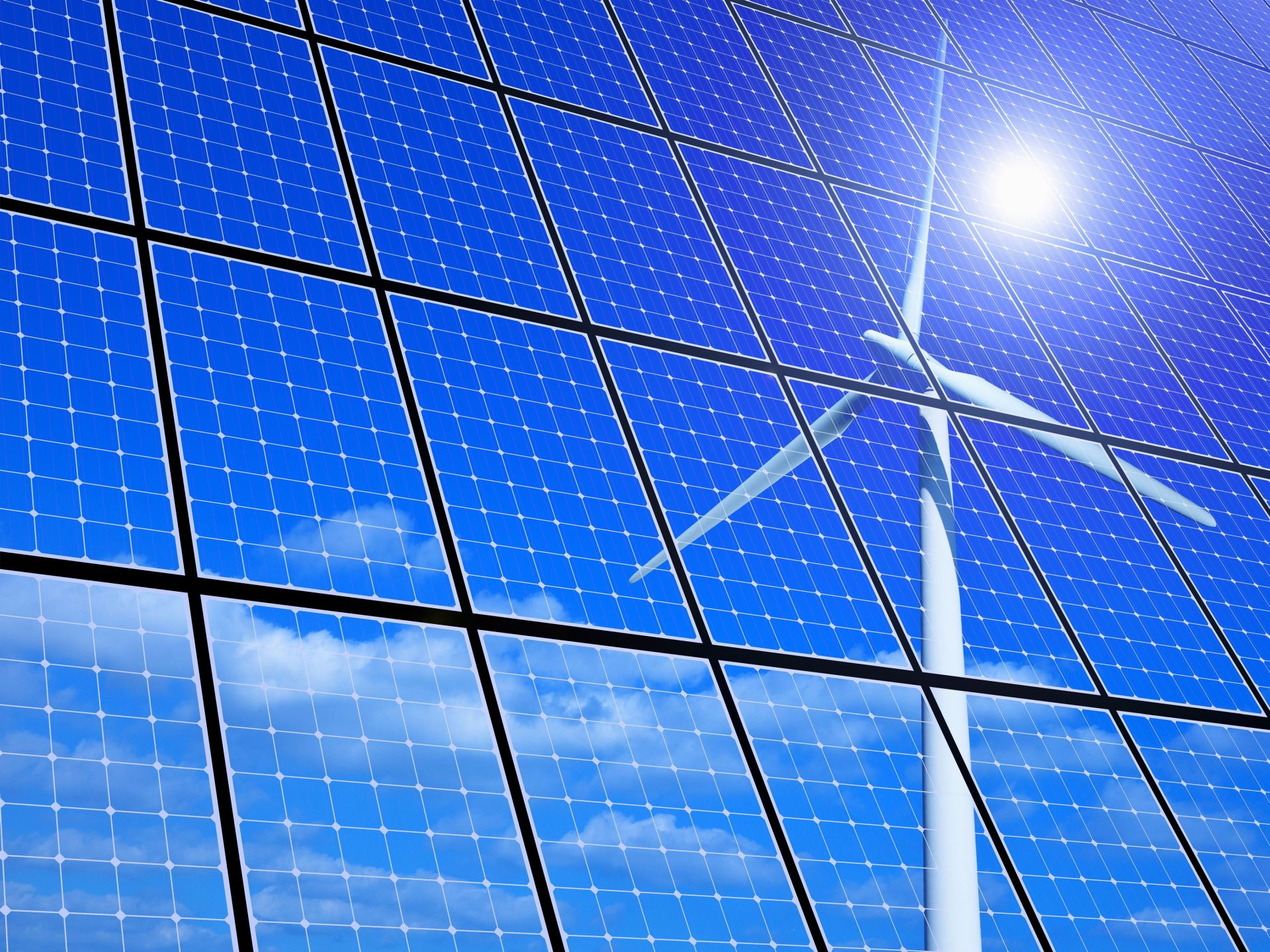 una pala eolica e dei pannelli fotovoltaici