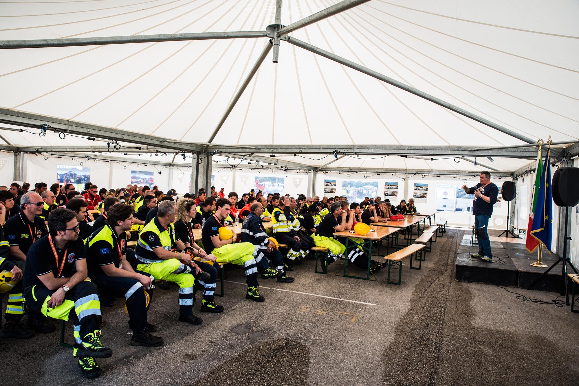 Una platea di persone in divisa della protezione civile